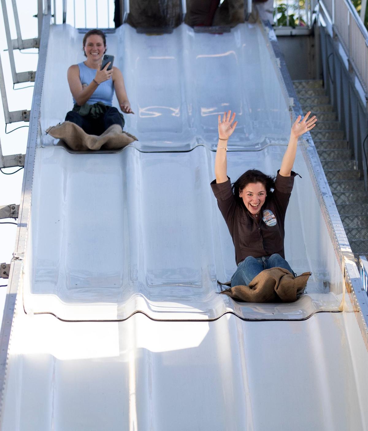 Tribune reporters Chloe Shrager, right, laughs while riding the Alpine Slide as Kelsey Oliver takes video on Wednesday, July 17, 2024.