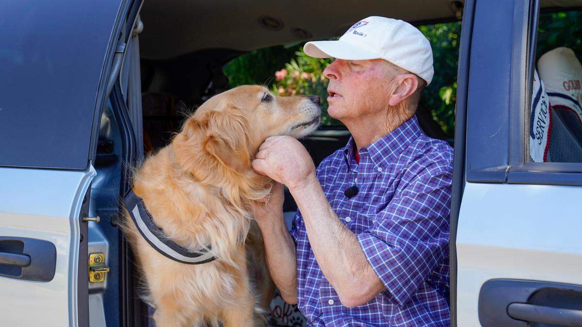 Dan Sievert, founder of Golden Missions of America, plays with his service dog, Cooper. Dan Sievert and his golden retrievers have made 55 missions across the United States over the past decade, helping victims of tragedies work through their trauma.
