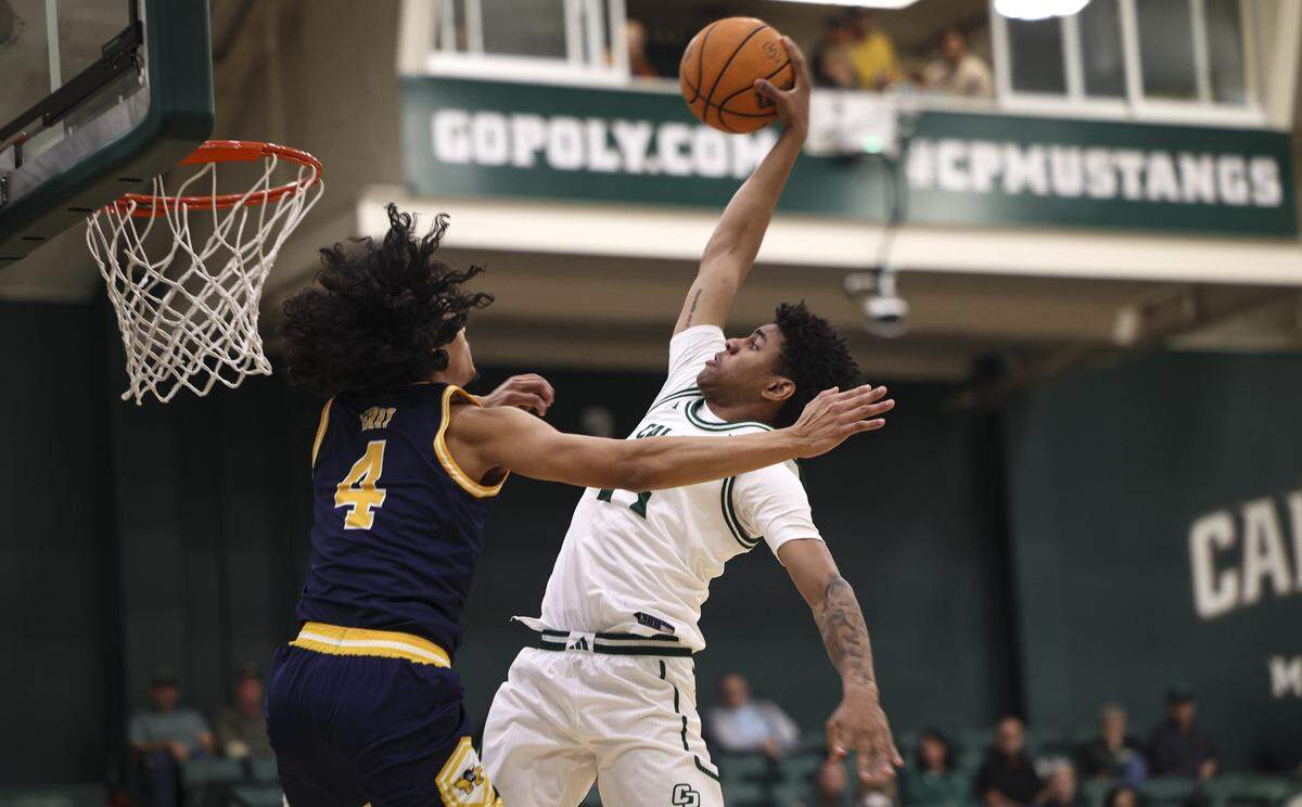 Cayden Ward dunks over Andre Henry. Cal Poly men scored an upset basketball victory over U.C. Irvine 79-73 on Feb. 12, 2026.