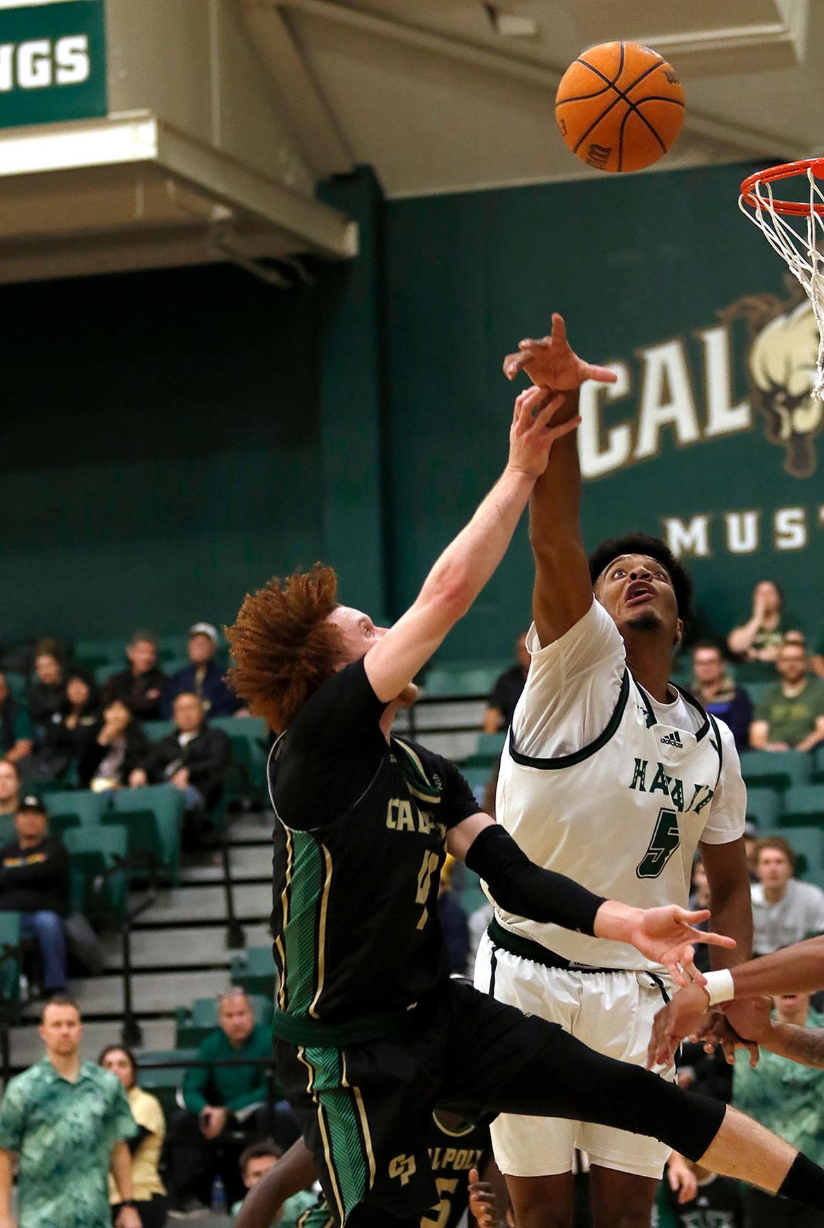 Cal Poly’s Brantly Stevenson (4) gets past Hawaii’s Bernardo da Silva (5) block. Cal Poly fell to Hawaii 69-56 in a men’s basketball game at Mott Athletic Center in San Luis Obispo on Saturday, Feb 4, 2023.