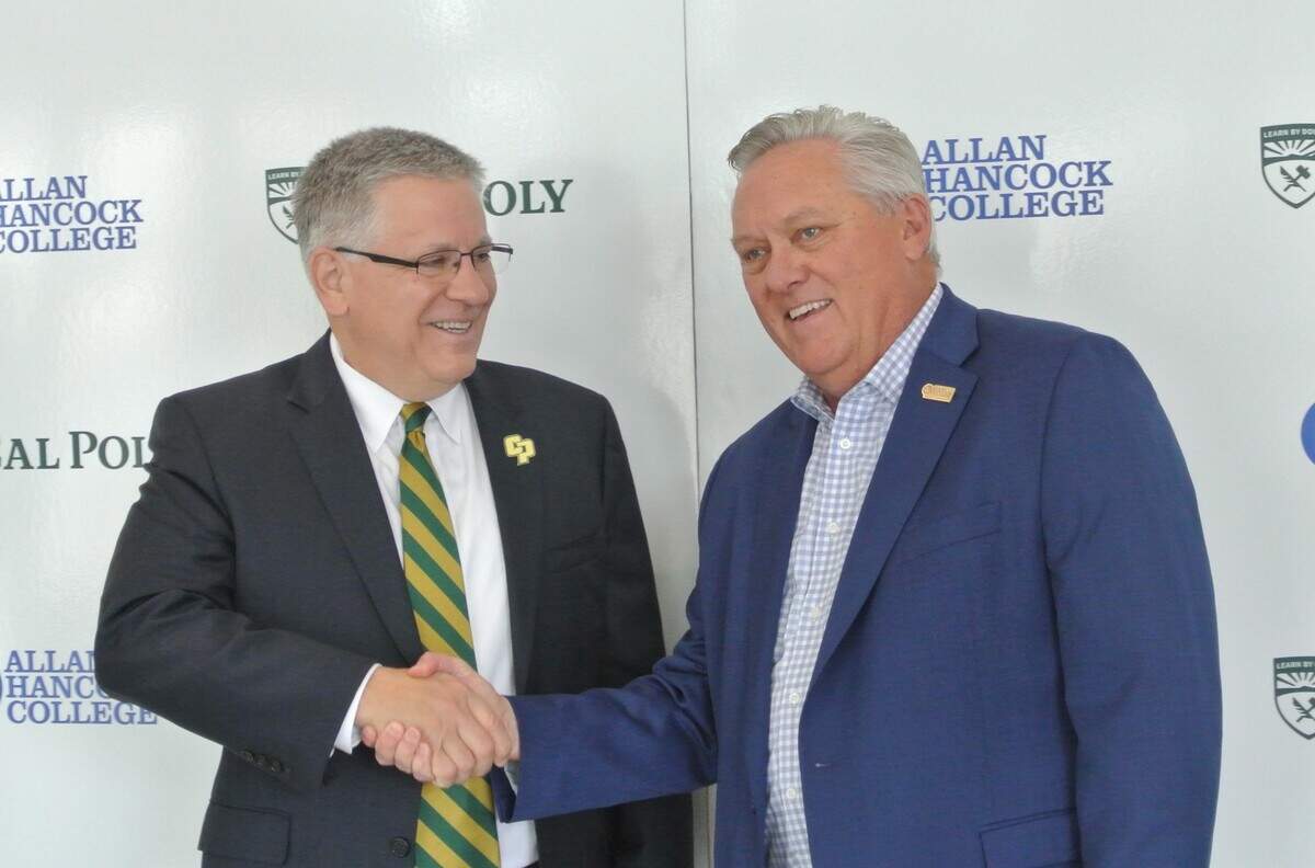 Cal Poly President Jeffrey Armstrong and Allan Hancock College President Kevin Walthers shake hands at a news conference announcing a partnership between the two colleges to expand access to bachelor’s degrees. March 17, 2025