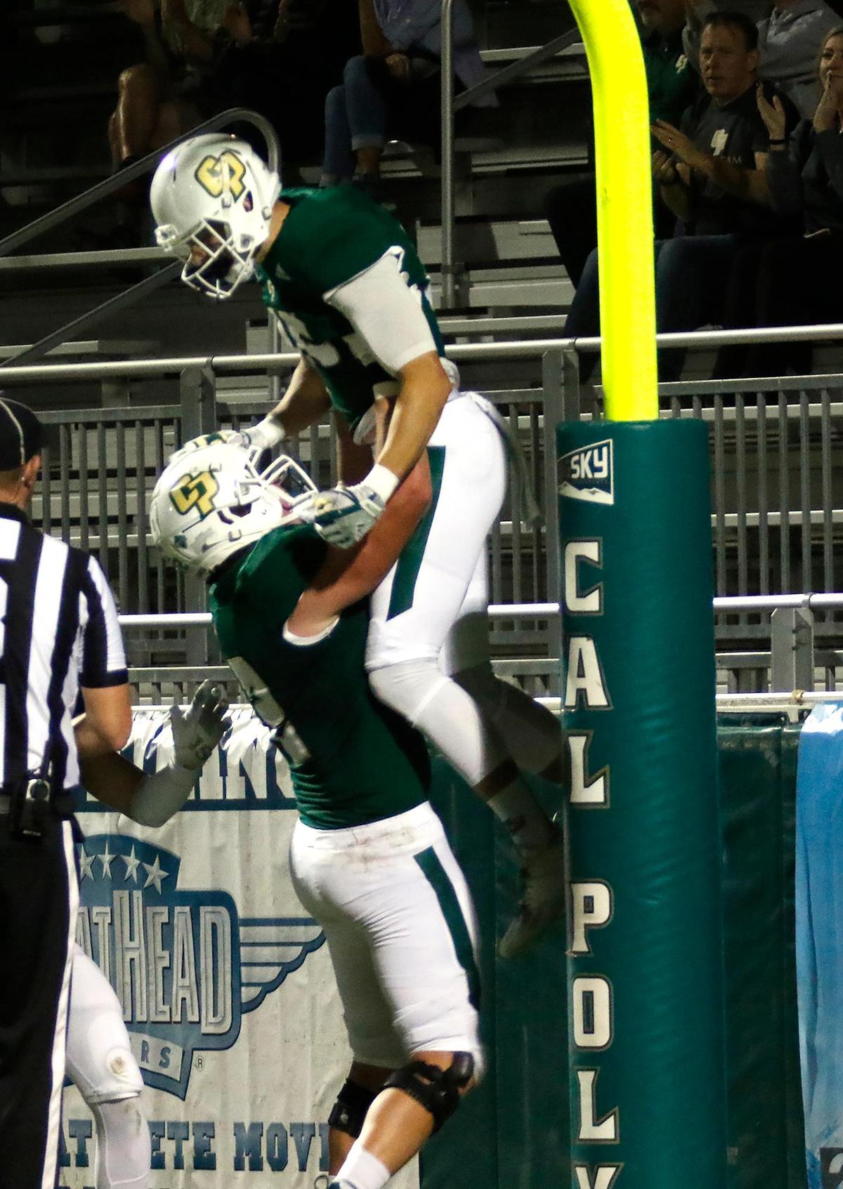 Cal Poly’s Austin Anderson (72) lifts Michael Roth (85) after Roth scored the first touchdown of the Mustangs’ 32-29 win over Idaho State at Alex G. Spanos Stadium on Nov. 13, 2021.