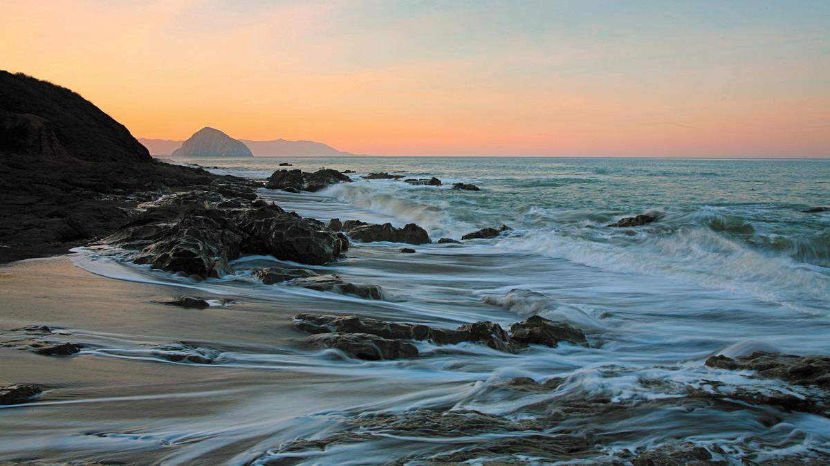 The swirling water around boulders and rocks in Sam Peck's 'Tidal Motion' was taken at the southern end of Cayucos Beach, with Morro Rock in the distance.
