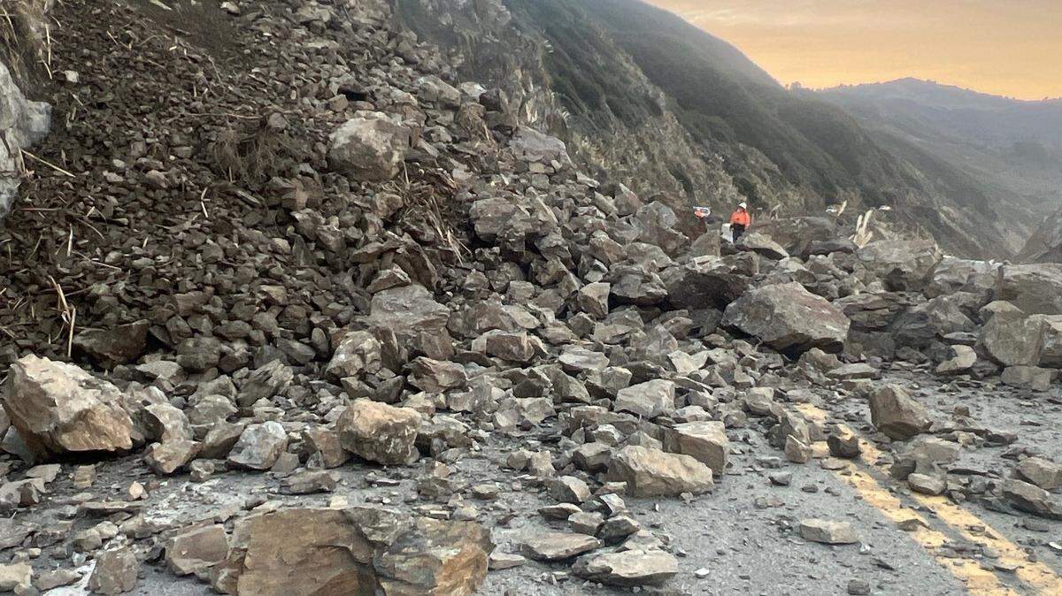 Caltrans workers assess a slide that sent rocks and boulders tumbling onto Highway 1 south of Lucia. Caltrans discovered the slide on Tuesday, Jan. 6, 2026, and were was able to clear it by the next day.