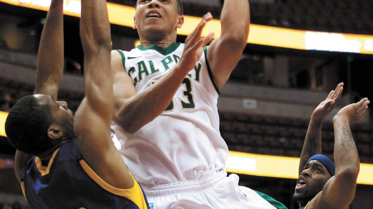 Cal Poly’s Chris Eversley leans in to get a shot off over UC Riverside’s Phil Martin (12) during Thursday’s quarterfinal game of the Big West Conference Tournament at the Honda Center in Anaheim. Cal Poly won 66-54 with Eversley scoring 11 points.