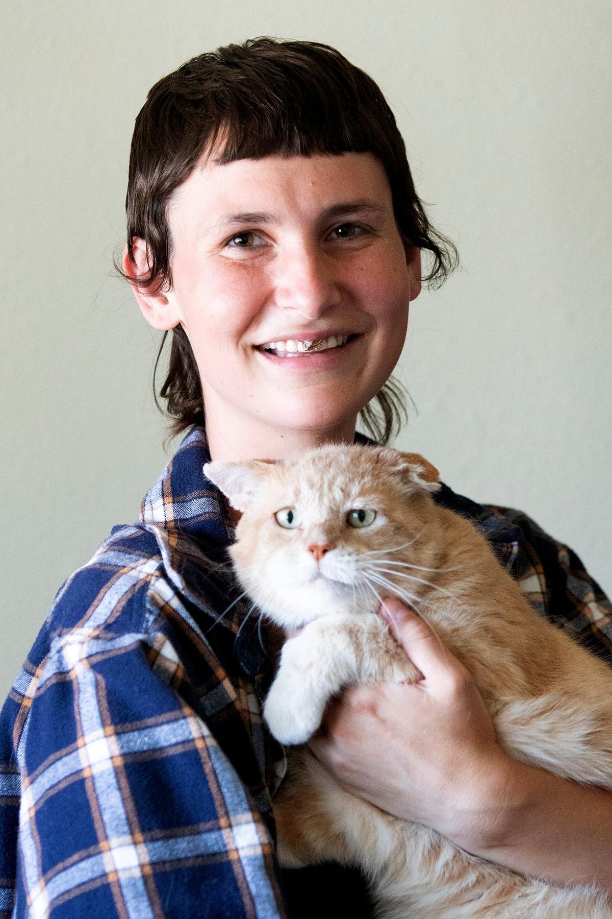 Faith LeGrande, a San Luis Obispo resident and business owner who suffers from multiple dynamic disabilities, poses with their cat, Rook.