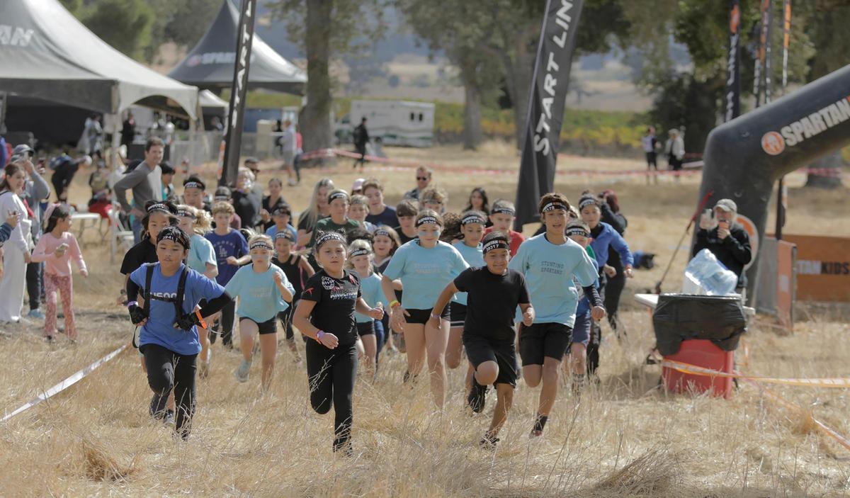 Kids take off at the Spartan race event held in Santa Margarita on Saturday, Nov. 2, 2024, featuring a variety of obstacles and courses of different challenge levels.