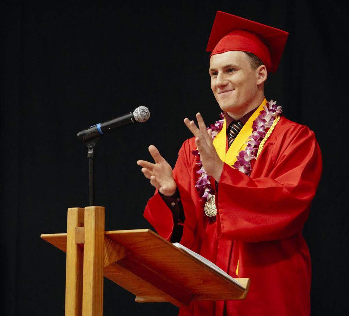 Salutatorian Riley Kennedy leads the crowd in applause for the teachers and staff during the Coast Union High School graduation in 2018.