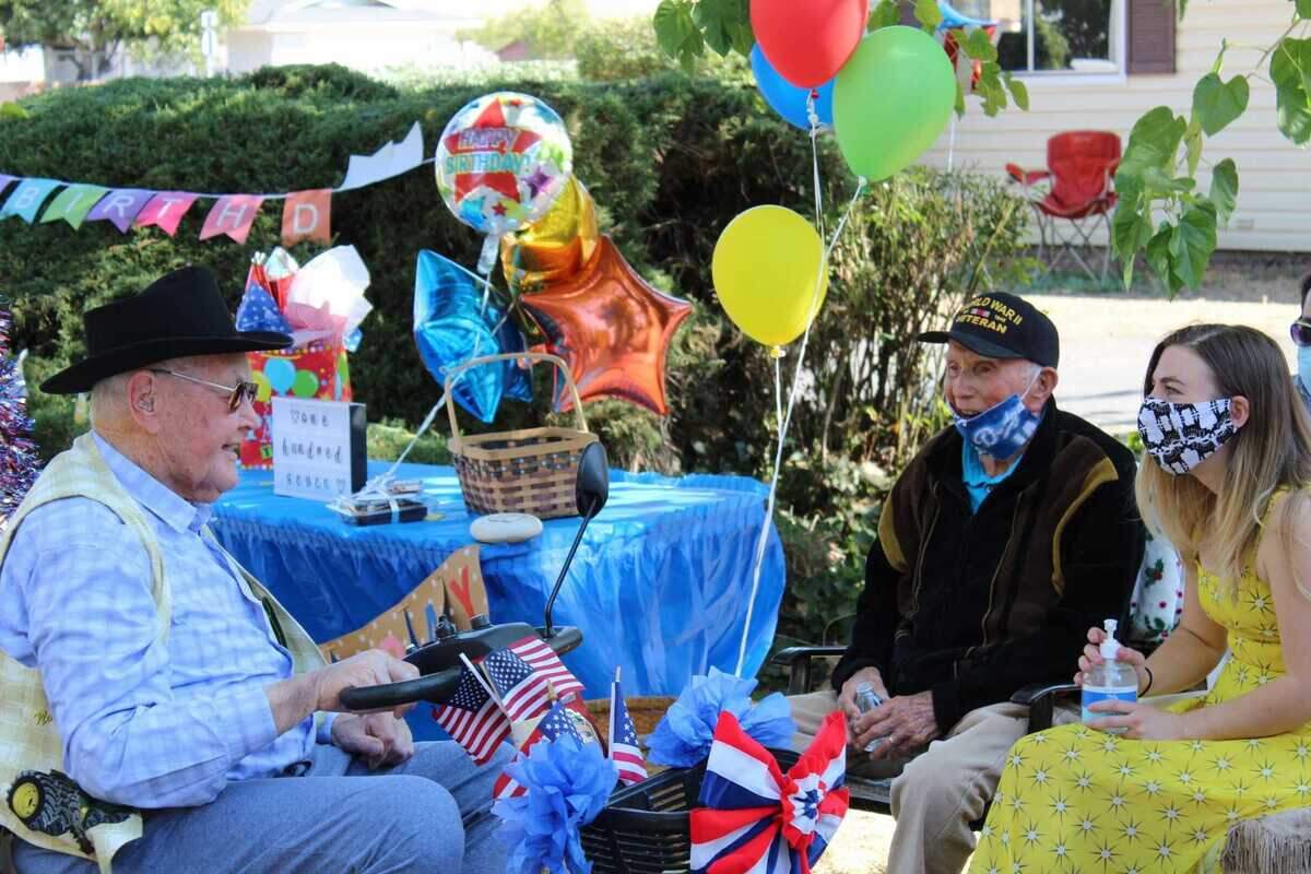 Howard Lowe, left, and Henry Barba, center, have known each other for more than 90 years. The two would play “kick the can” and marbles as kids.