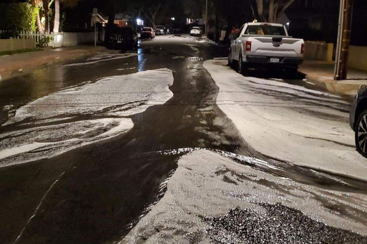 Drifts of hail are seen on Mountain Avenue on Santa Barbara’s Westside.