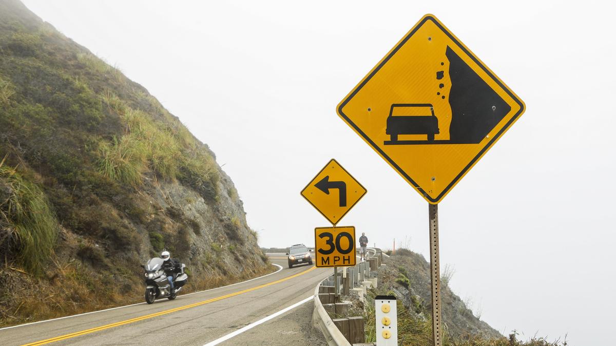 Vehicles drive around a corner on Highway 1 in 2018 near the newly opened section across the Mud Creek Slide. Caltrans is closing a section of the highway in advance of heavy rains and strong winds.