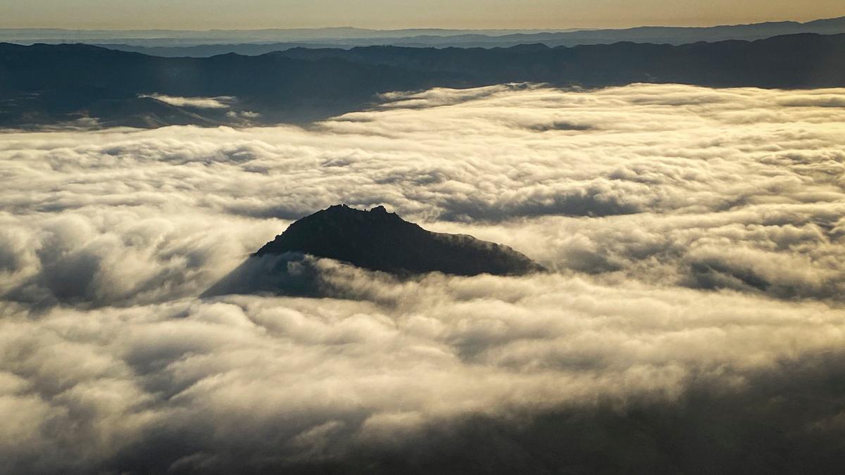 Bishop Peak is shrouded in fog in a view from an Alaska Airlines flight as it takes off from San Luis Obispo County Regional Airport on the way to Seattle on the morning of July 16, 2024.