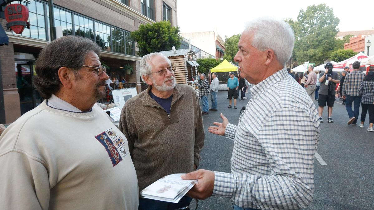 Republican candidate for governor John Cox brought his statewide “Help Is On The Way” bus tour to the Downtown San Luis Obispo Farmers’ Market on Thursday, September 27, 2018. Cox is speaking with Steve Nabhan, left, and Robert Cohen.