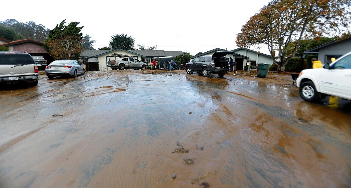 The residents of Vista Court in Los Osos clean up after their neighborhood on Tuesday, Jan. 10, 2023, one day after a flood of mud and water inundated several homes.