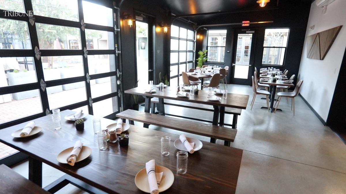 The back seating area at Bear & the Wren features roll-up doors that allow the space to be opened to the outdoors.