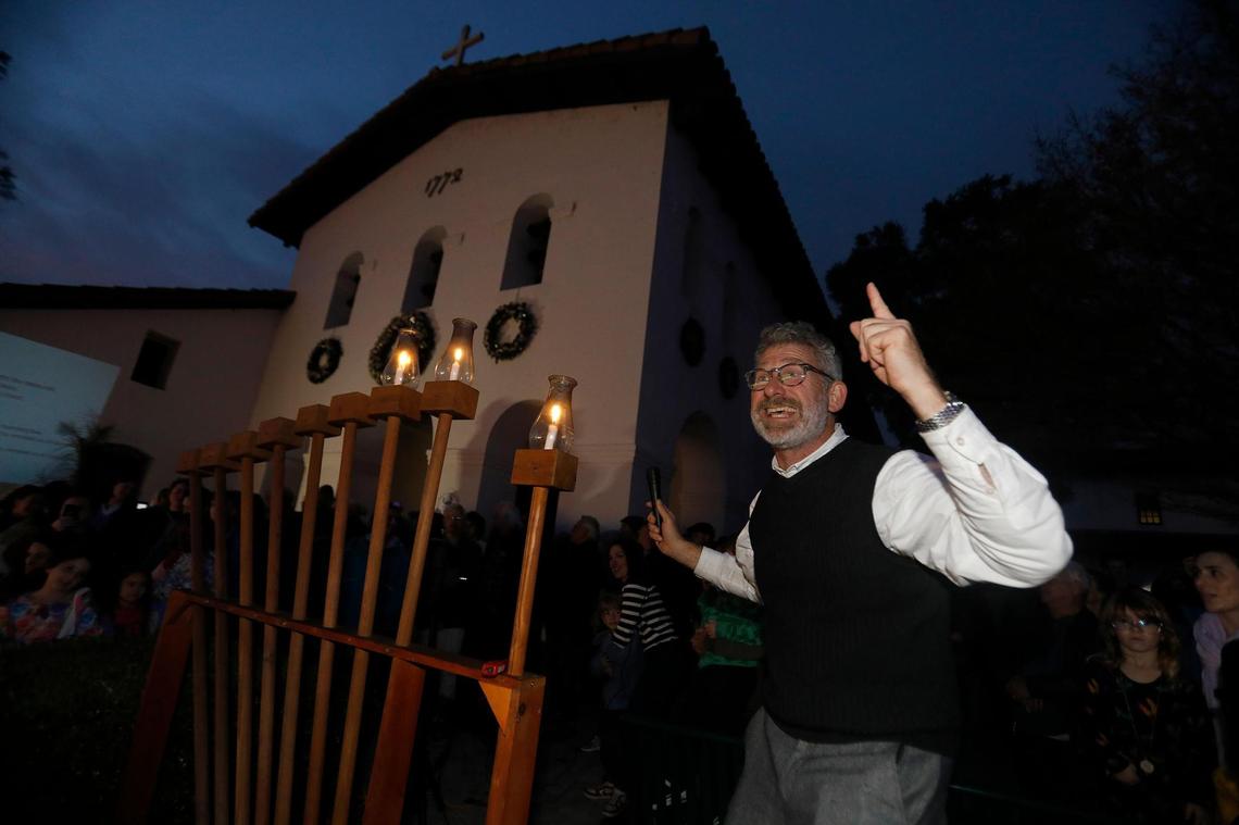 San Luis Obispo’s Jewish community gathered with friends and neighbors on Dec. 26, 2024, for the city’s annual Hanukkah celebration downtown. Rabbi Micah Hyman conducts the lighting ceremony. 