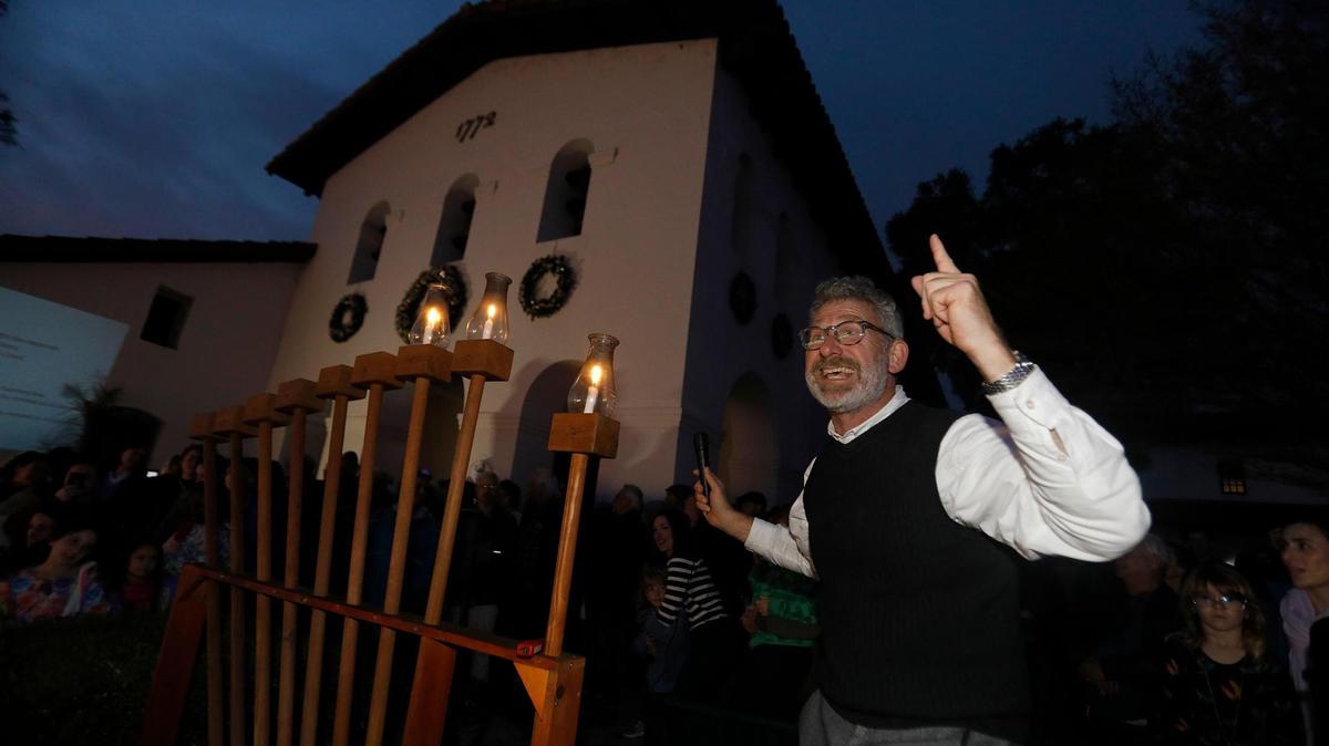 San Luis Obispo’s Jewish community gathered with friends and neighbors on Dec. 26, 2024, for the city’s annual Hanukkah celebration downtown. Rabbi Micah Hyman conducts the lighting ceremony.