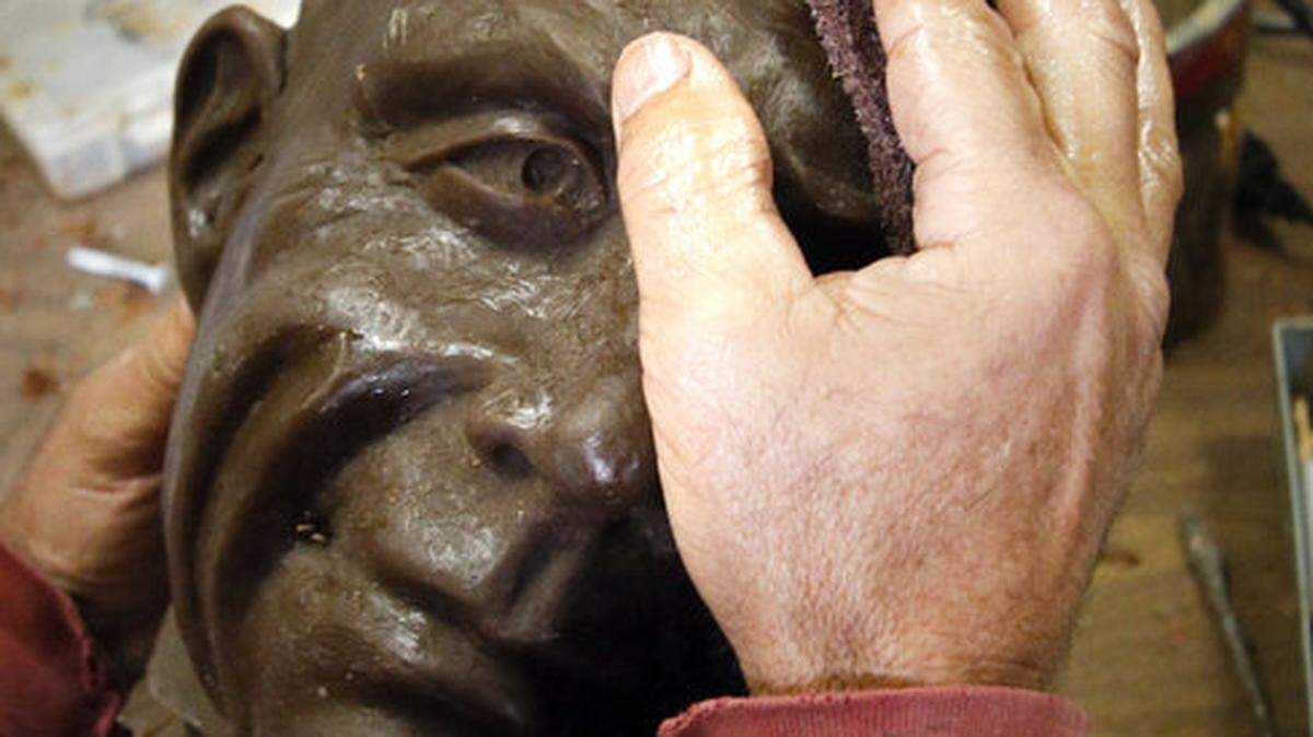 Artist Mark Greenaway works on a statue of Charles Paddock that will stand outside the Atascadero zoo that bears his name. 