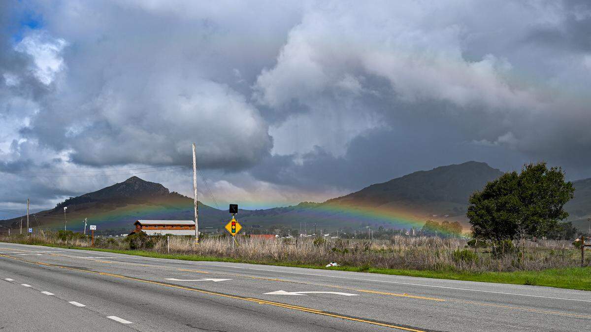 A low rainbow arches under cloudy skies last week in San Luis Obispo.