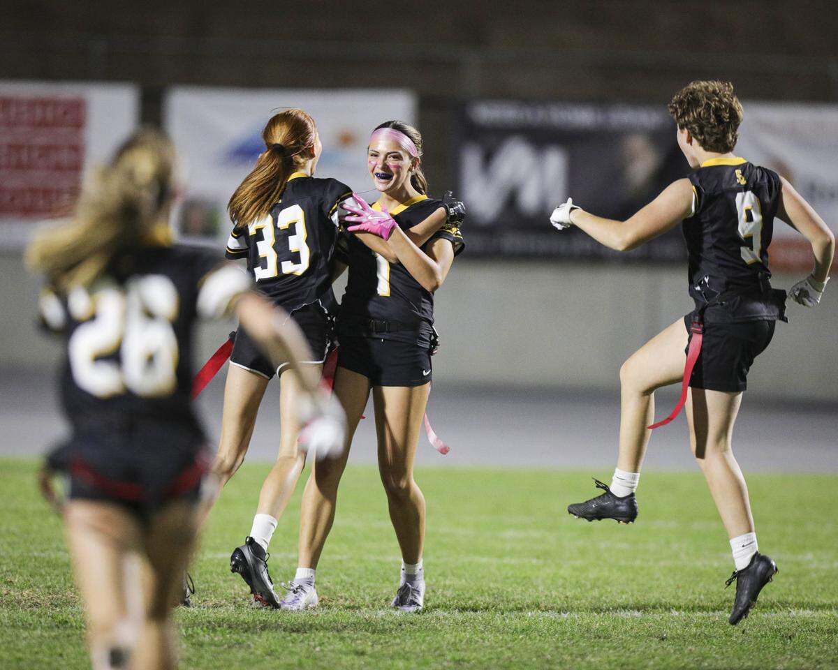 Emily Peters, left, Eriana Roberts, Aurora Peterson and Giana Boscaro celebrate a touchdown. San Luis Obispo beat Santa Maria 51-6 in a girl's flag football game seen here on Oct. 16, 2025.