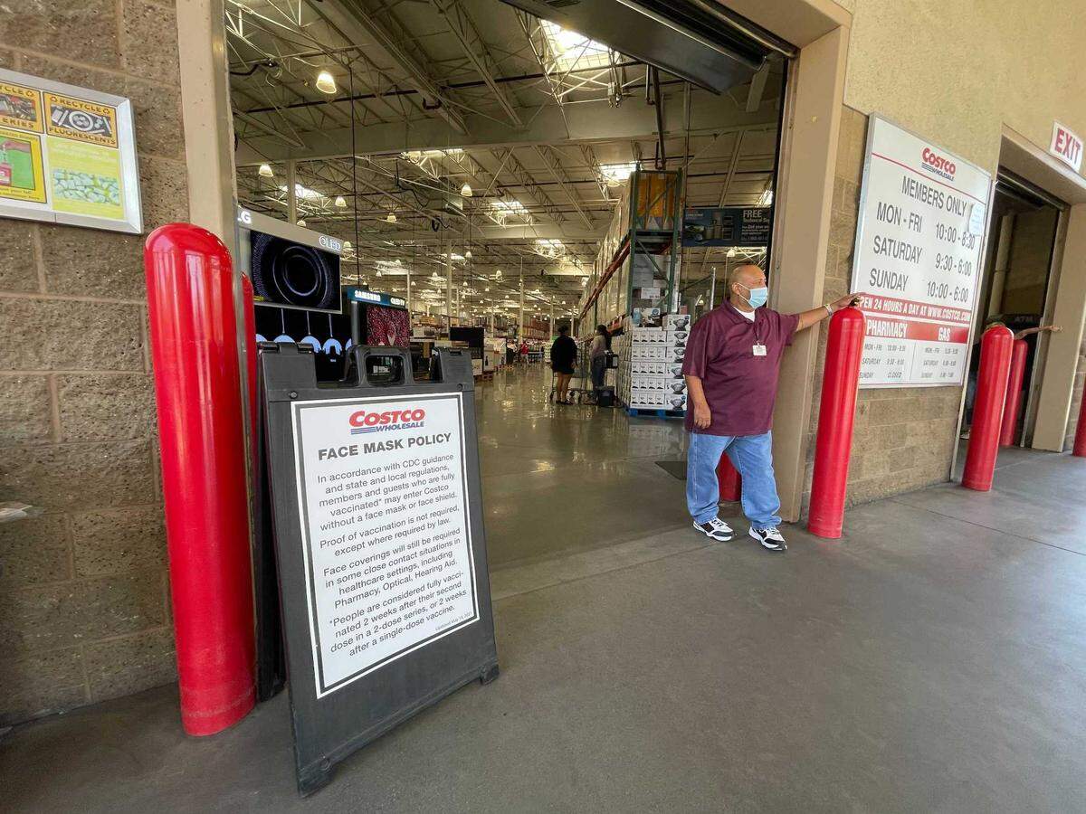 Costco workers are still wearing masks, but new signage now asks only unvaccinated customers to wear them.