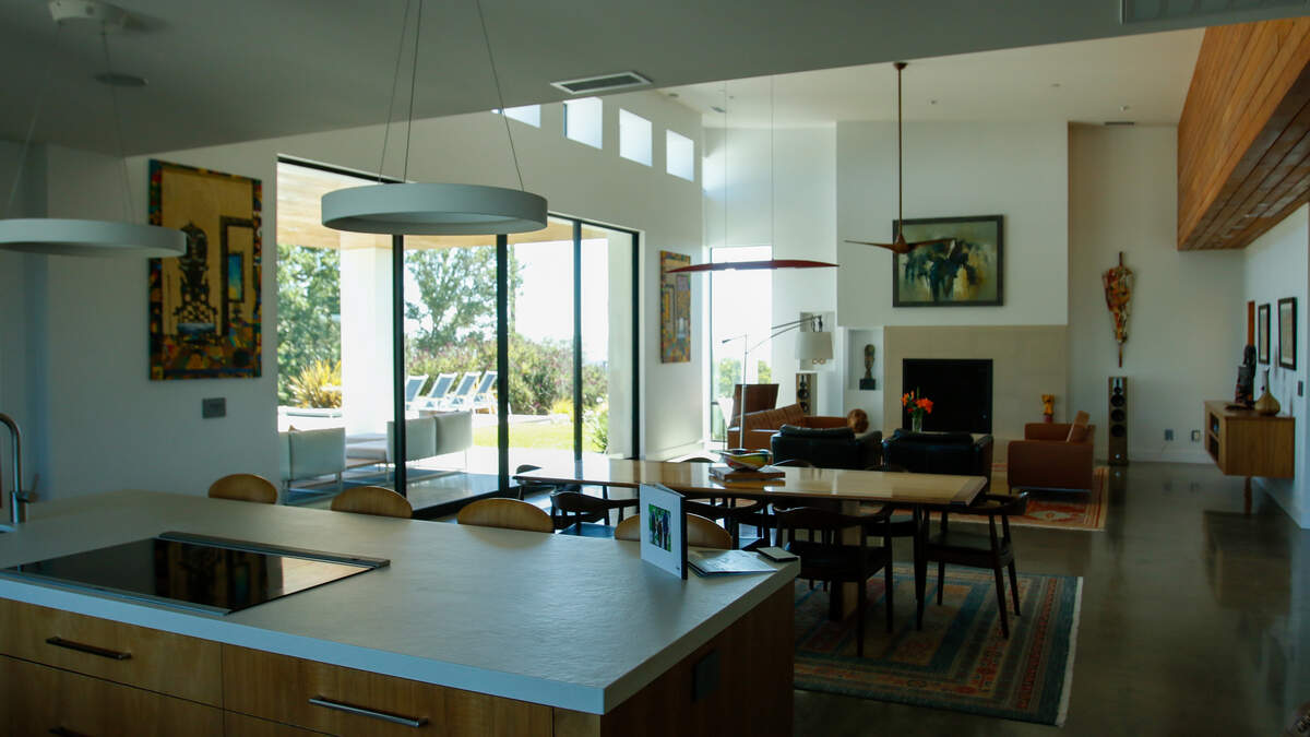 The living room of a 705 Sequoia Lane estate currently for sale looks out over rolling vineyards and farmland on Wednesday, June 10, 2026. The 12-acre estate features the first commercial planting of Nero di Troia grapevines — native to Italy’s Puglia region — in the United States.