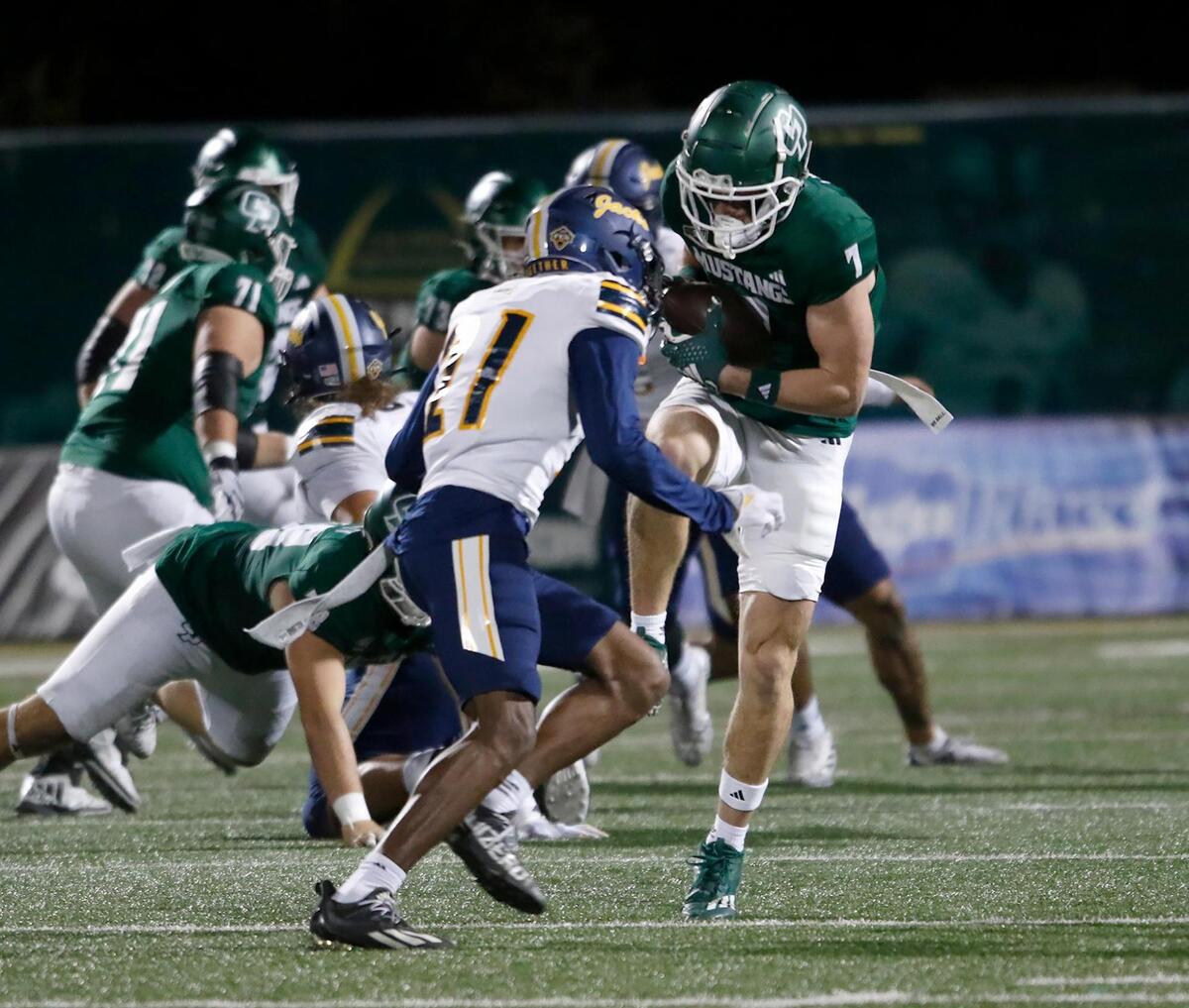 Cal Poly wide receiver Jake Woods gets tackled by the LumberJacks’ Mikale Greer. Cal Poly lost to Northern Arizona 31–14 in a college football game at Mustang Memorial Field on Nov. 9, 2024.