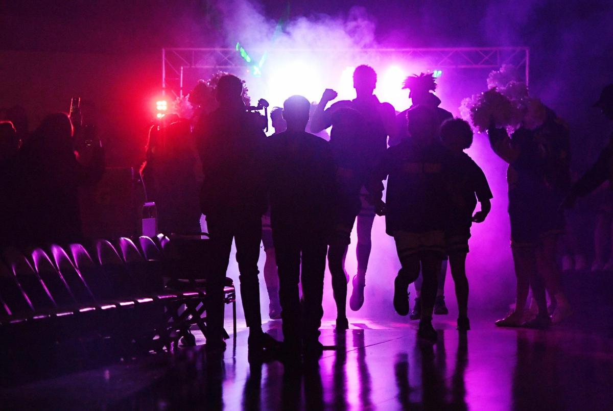 Arroyo Grande takes the court amid a colorful light show at the CIF Central Section boys Division 2 basketball championship Friday, Feb. 24, 2023, in Fresno. Arroyo Grande beat Porterville 59-30.