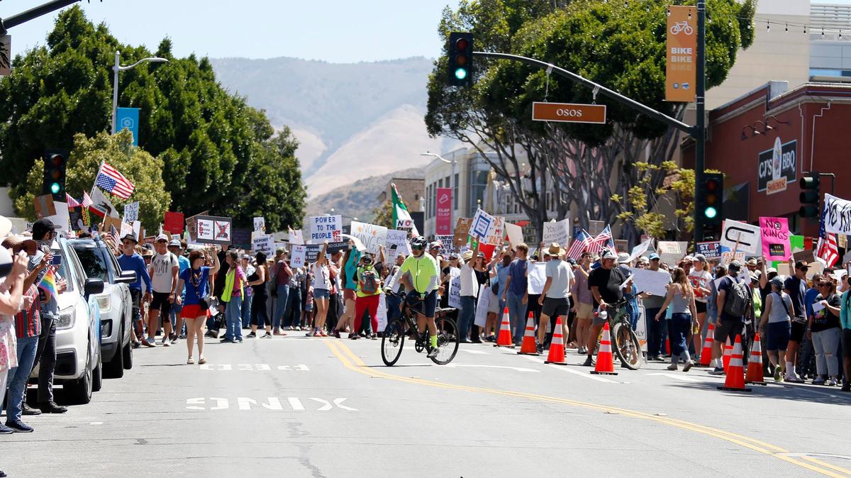 Protest attendees march down Monterey Street in San Luis Obispo  at a June 2025 rally to take a stand against what they see as the Trump administration’s overreach of executive power.