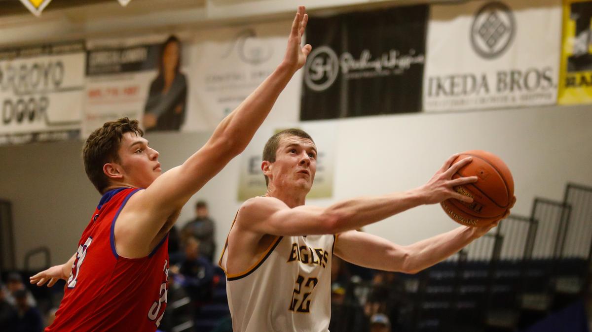 Arroyo Grande High School’s Bryan Smith shoots over Kyler Van Grouw of Buchanan in a first-round game Wednesday night of the CIF-Central Section Division I playoffs.