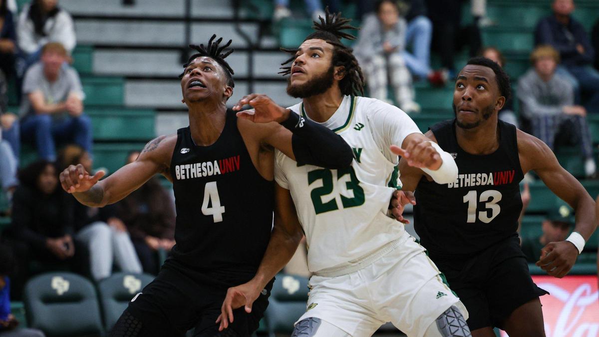 From left, Daniel Estes, Bryan Penn-Johnson and Russell Redwood battle for rebound position. Cal Poly basketball opened its season with a 94-59 win against Bethesda University on Nov. 7, 2022.
