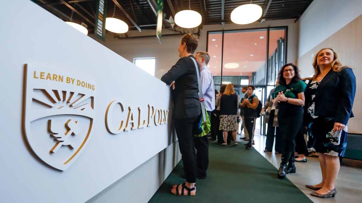 Cal Poly opened a new Welcome Center on Tuesday on Grand Avenue, featuring the university’s updated logo. Royaa Silver, assistant vice president for creative services, university marketing, and Cindy Villa, senior vice president for administration and finance, at right, look over the new facility.