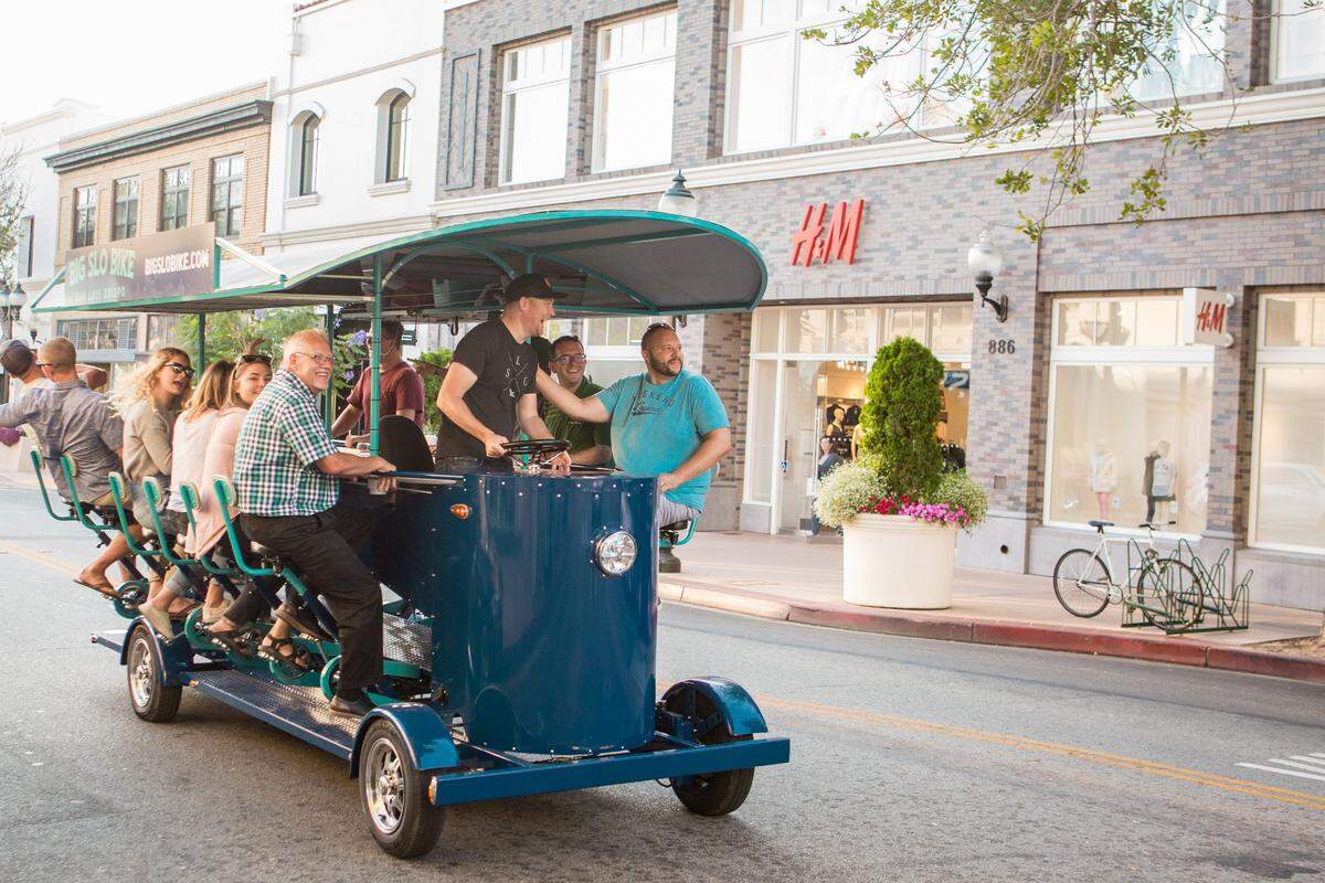 The Big SLO Bike, captained by Johnny May, cruises down Monterey Street.