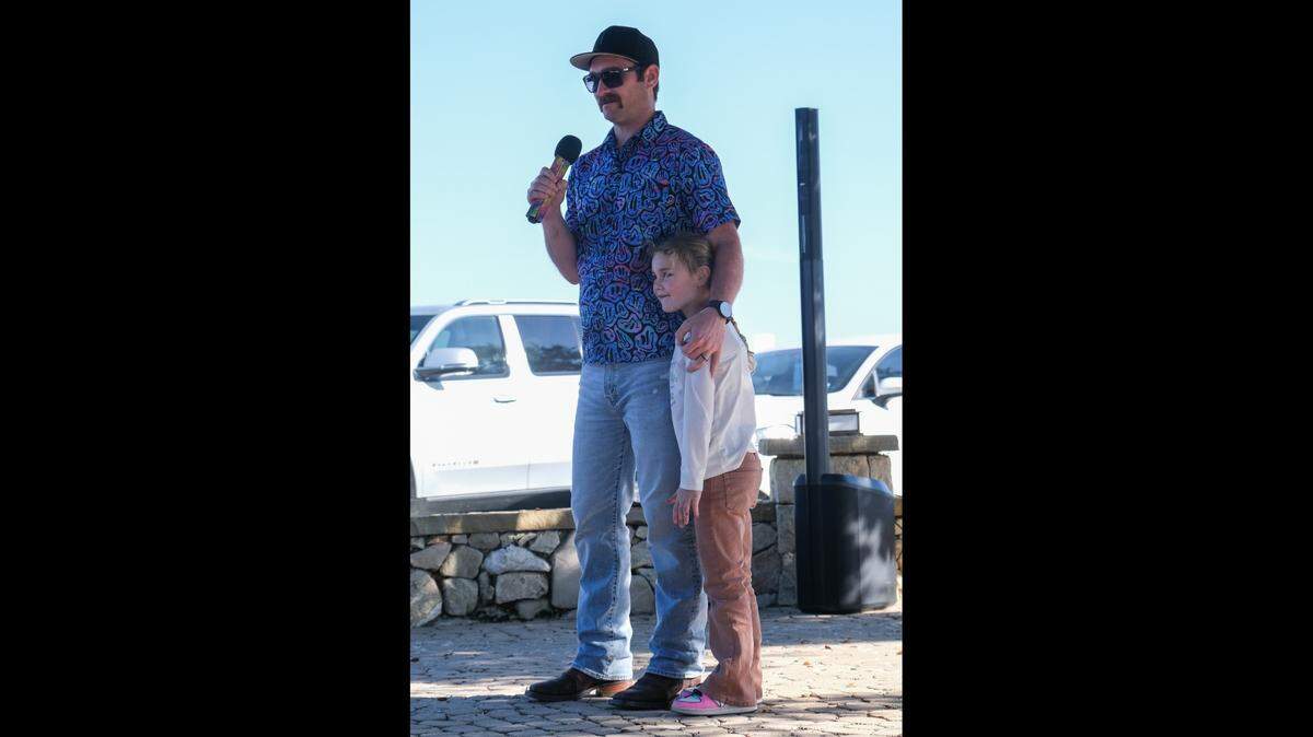 Roger Smith, left, shares one of his favorite stories about Todd Pinion, who was killed in an alleged hate crime on Oct. 23, 2024, at Pinion’s memorial on Nov. 10, 2024. Smith said Pinion gave his daughter a unicorn sweater for Christmas.