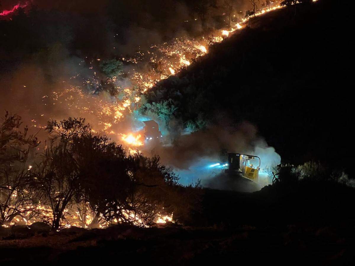 Two dozers carve fire lines while battling the Gifford Fire in San Luis Obispo County on Thursday night, Aug. 7, 2025.