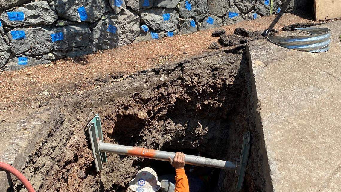 A road crew member works to complete repairs on 27 damaged culverts under the historic access road leading from the Hearst Castle visitor center to the former San Simeon estate of media magnate William Randolph Hearst in late November 2021.
