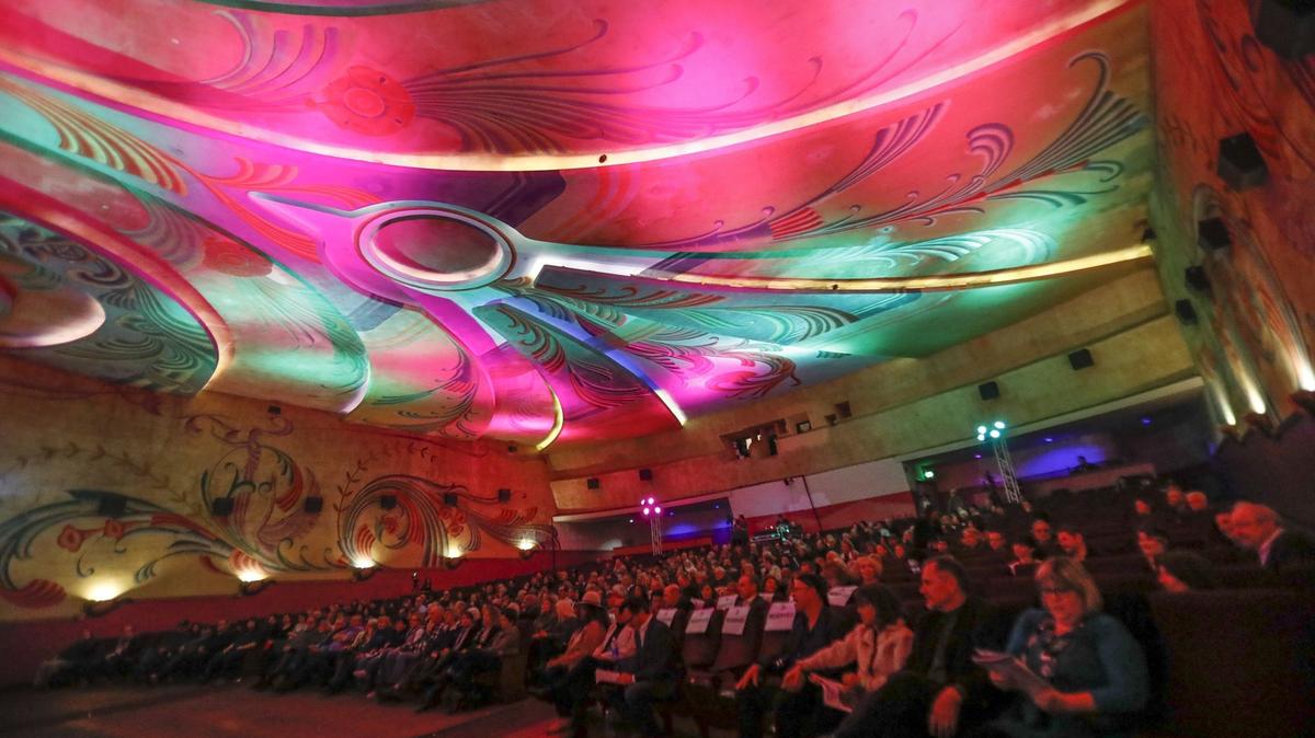 Audience members watch a video reel featuring clips from actress Pam Grier’s movies at the Fremont Theater in San Luis Obispo during the King Vidor and Independent Film Awards, part of the 2018 San Luis Obispo International Film Festival. The film festival returns with in-person screenings this year after two years of virtual only.