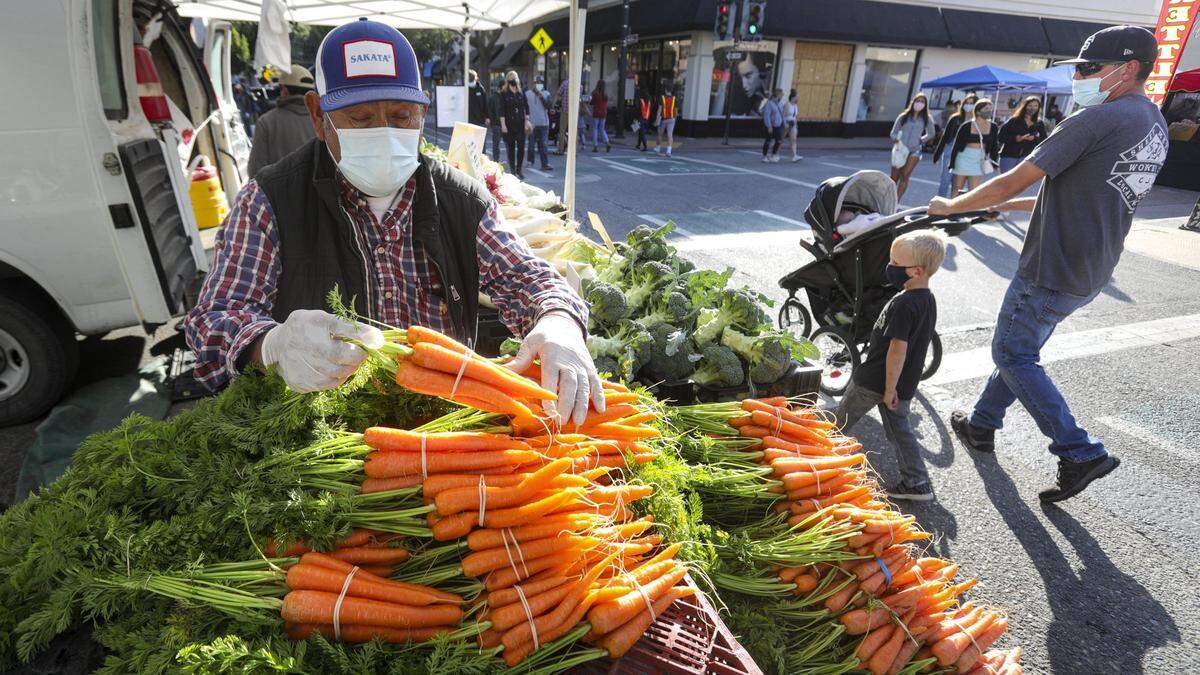 Francisco Velazquez of Santa Maria sets out carrots from his farm on May 6, 2021. The Farmers’ Market will fully re-open its five blocks of vendors on Thursday, June 17, 2021.