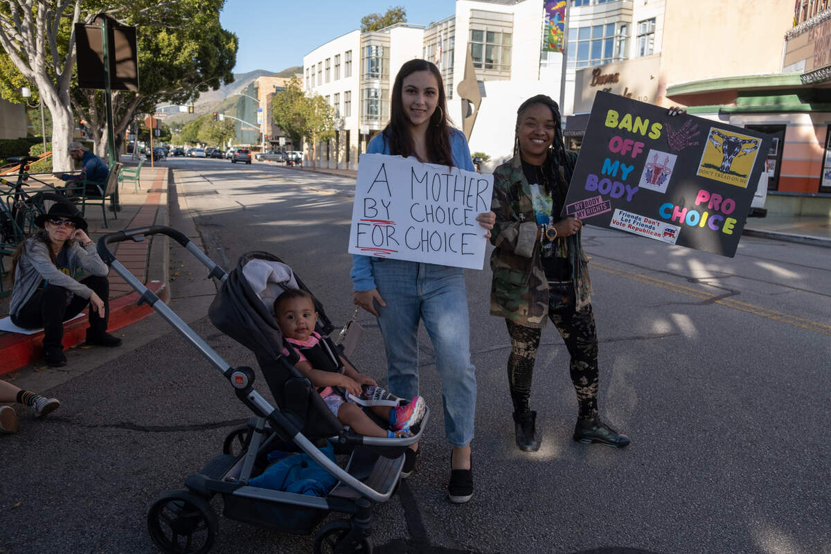 Pilar Ortega, center, with her daughter and her friend at a rally supporting abortion rights in downtown San Luis Obispo on May 3, 2022. Ortega said she chose to be a mother, but she would not chose to have a second child because she needs to be 100 percent there for her daughter. She said she will continue to fight for other mothers to be able to continue to have this choice.