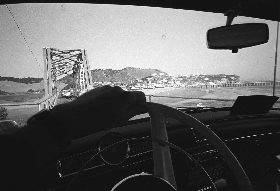 Avila Beach, Pacific Coast Railway bridge and Union Oil tanks from inside car. After a tour of the Port San Luis construction on Oct. 15, 1966. 