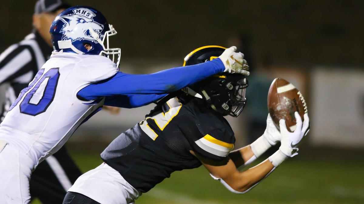 Max Soltero of SLO makes a touchdown catch as Logan Wattenbarger defends. San Luis Obispo High School beat Madera 49-28 to advance to the CIF-Central Section Division 3 semifinals.