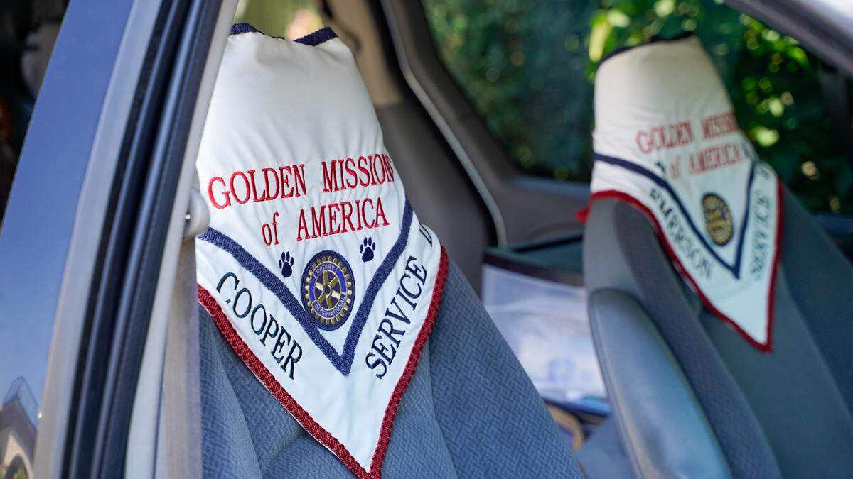 The bandanas worn by dogs with Golden Missions of America hang from seats in Golden Missions founder Dan Sievert’s van. Sievert and his golden retrievers have made 55 missions across the United States over the past decade, helping victims of tragedies work through their trauma.