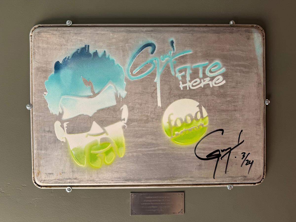 A commemorative plaque signed by “Diners, Drive-ins and Dives” host Guy Fieri hangs in the entrance of Taste! Craft Eatery in San Luis Obispo.