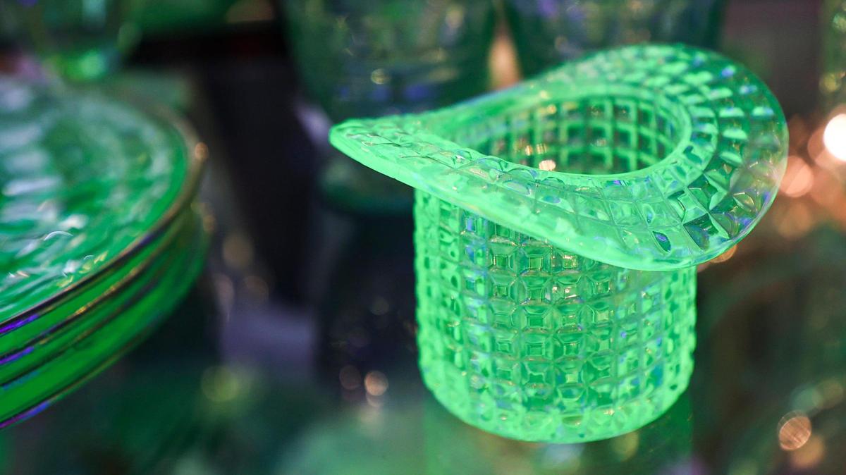 Uranium glass glows under a black light at Bizarre Antiques & Oddities is at the corner of Monterey Street and Johnson Avenue, seen here on April 3, 2025.