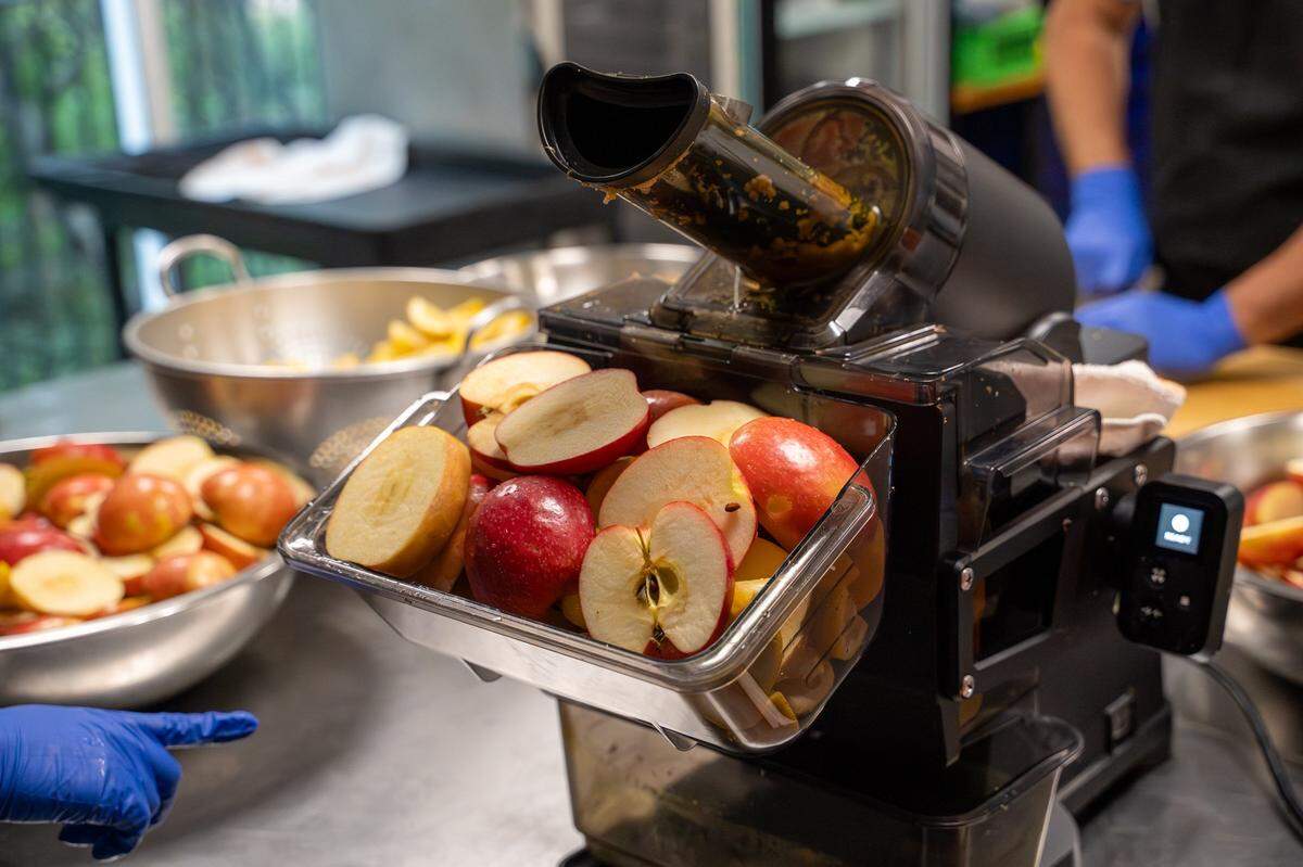 Apples and lemons sit in the basket of a juice press in the SLO Pressed kitchen at CaliPaso in San Luis Obispo on Thursday, May 14, 2026.