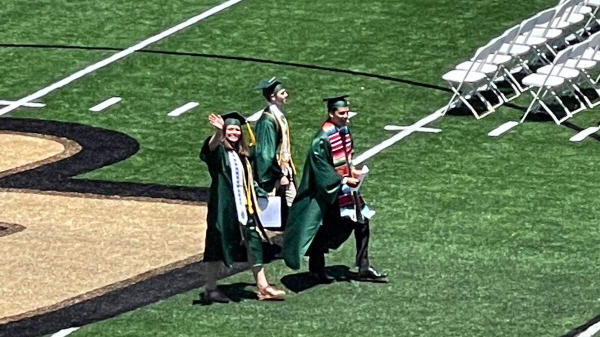 Lauren Tarica — aka Little Miss Cal Poly Grad — waves after her graduation on June 12, 2022, at Spanos Stadium.