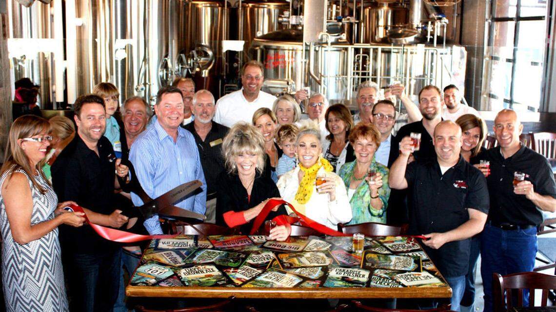 Figueroa Mountain Brewing Co. owners, employees and Arroyo Grande officials pose during the ribbon-cutting for the new taproom in Arroyo Grande.