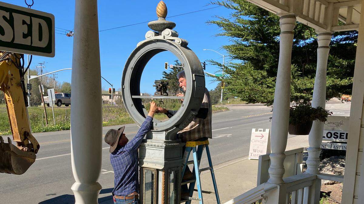 Josh Warren of Cambria and Billy Thomas of Morro Bay prepare to move a tall, heavy town clock nicknamed “Big Time” from in front of the Once Upon a Tyme clock/doll shop in Cambria. Shop owner Sue Foreman sold the clock to a Wisconsin collector.