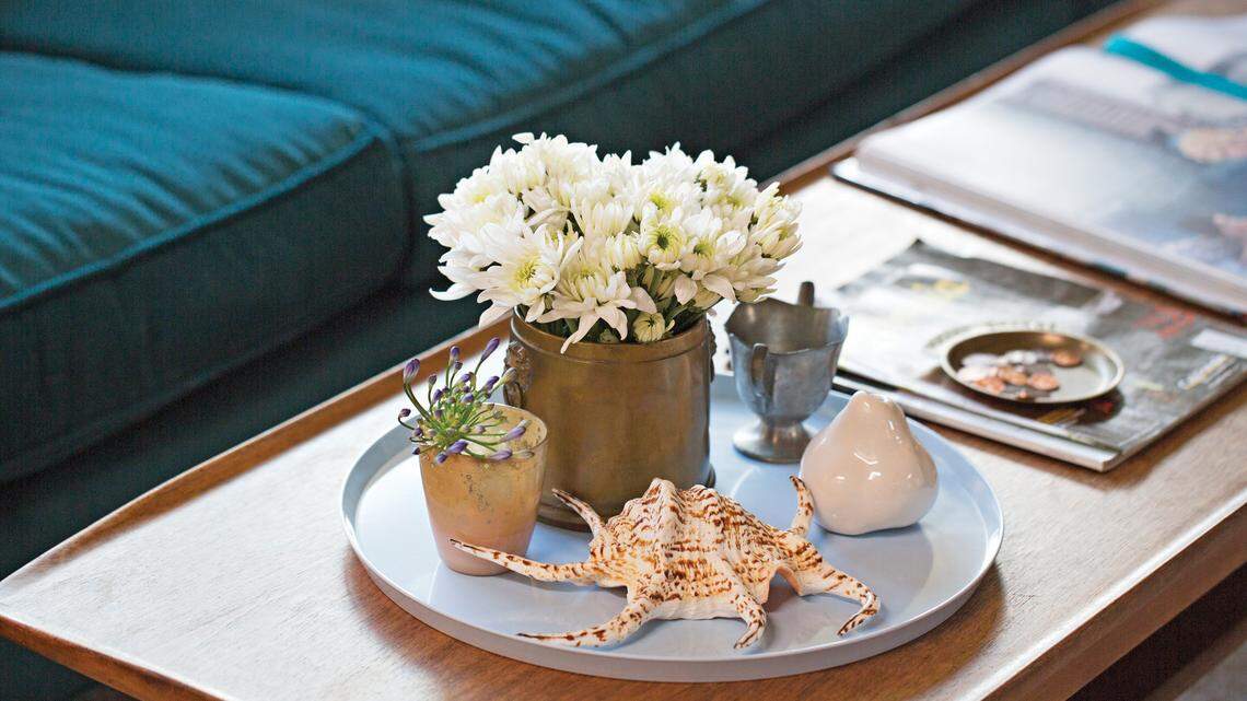 A melamine platter holds vintage collectibles on the coffee table.
