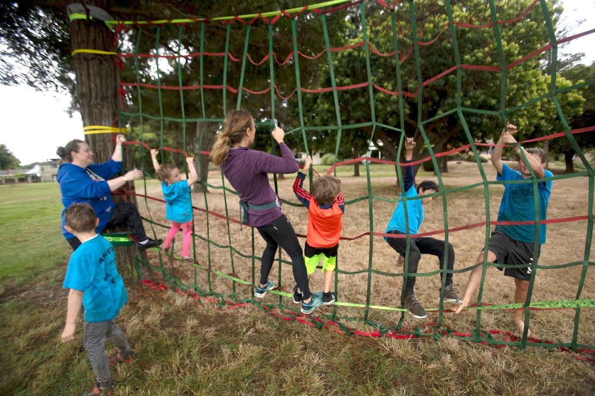 Kids navigate a climbing net at the sixth annual Laguna Lake September Scramble at the Laguna Lake Golf Course in San Luis Obispo on Saturday, Sept. 30, 2023.